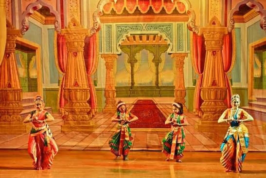 Ensemble of four dancers on an ornate palace set